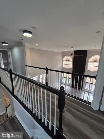 a view of an empty room with wooden floor