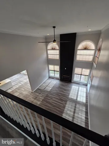 a view of empty room with wooden floor