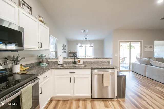 a kitchen with a sink stove and cabinets