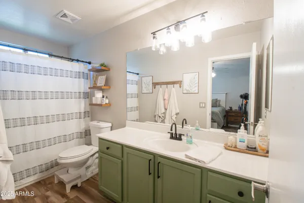 a bathroom with a sink toilet a shower and a mirror