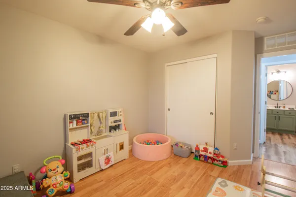 a bedroom with baby toys and wooden floor