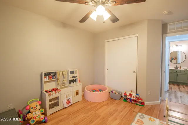 a bedroom with baby toys and wooden floor
