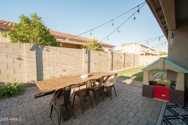 a patio with table and chairs