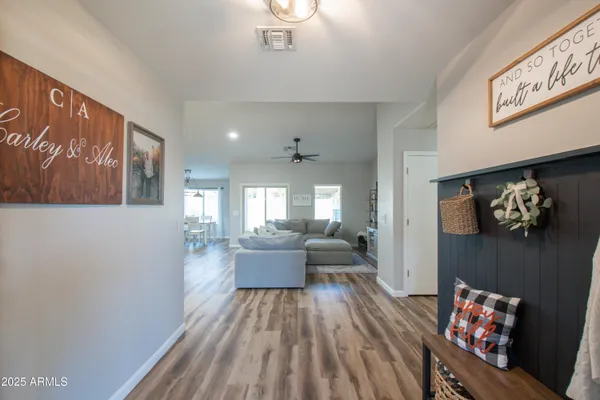 a living room with furniture and wooden floor