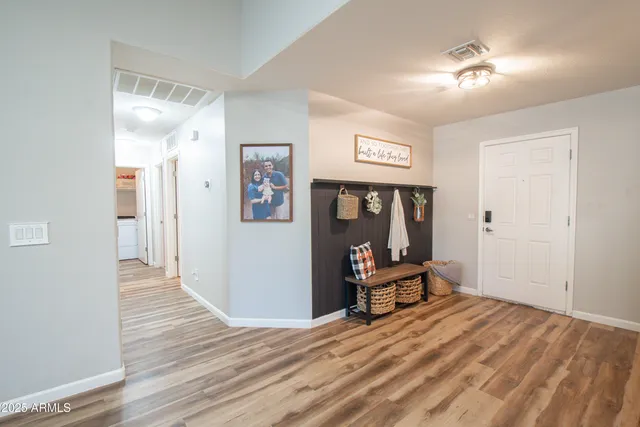 a view of a room with wooden floor and furniture