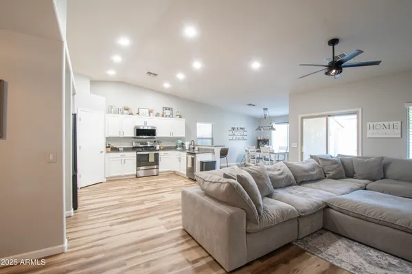 a living room with furniture and kitchen view