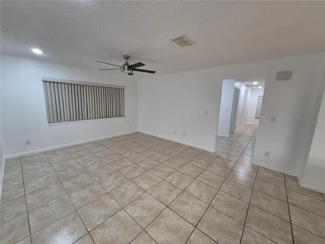 a view of a livingroom with a chandelier furniture and windows