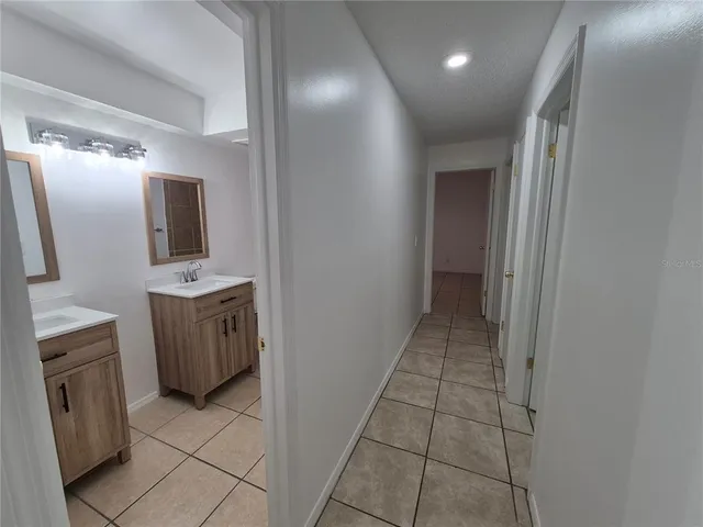 a bathroom with a double vanity sink mirror and toilet
