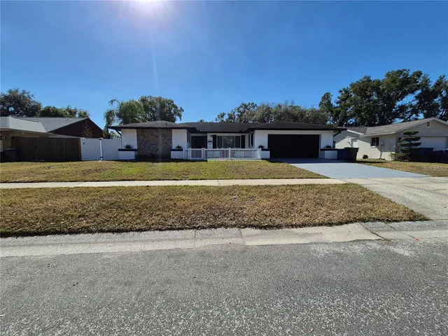 a view of a house with a yard and sitting area