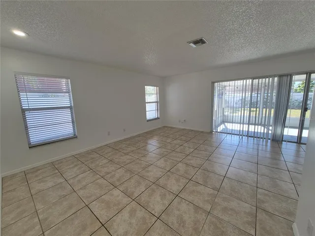 a view of an empty room and a window