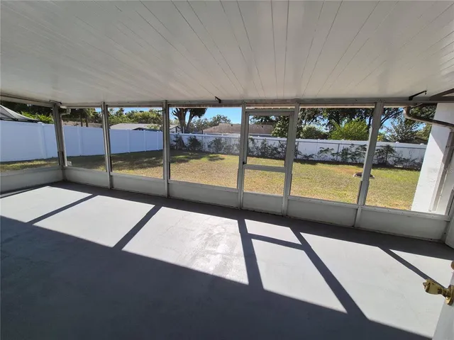 a view of an empty room with a floor to ceiling window