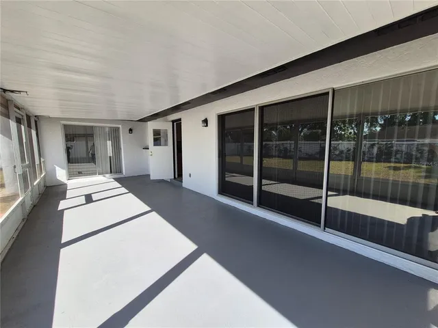 a view of a swimming pool with an outdoor seating and a yard