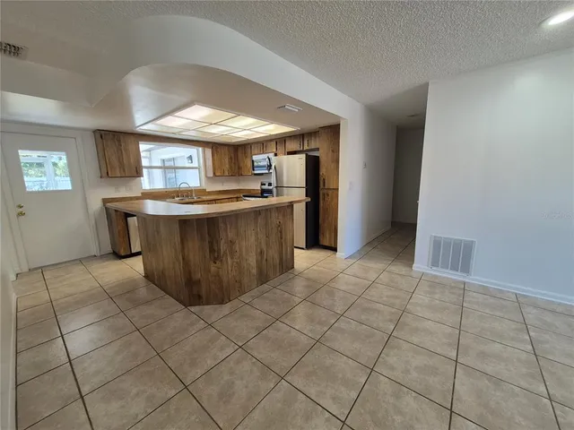 a kitchen with stainless steel appliances a sink stove and cabinets