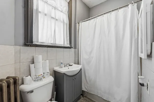 a bathroom with a sink a toilet and a mirror