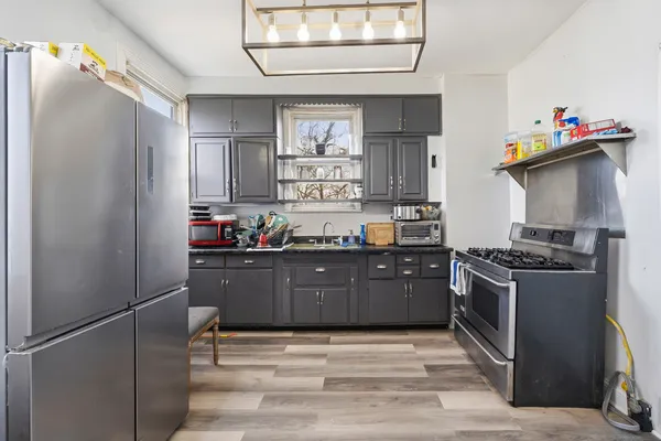 a kitchen with stainless steel appliances granite countertop a refrigerator and a sink