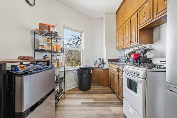 a kitchen with stainless steel appliances granite countertop a stove a sink dishwasher and cabinets with wooden floor