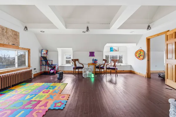 a playing room with furniture and a wooden floor