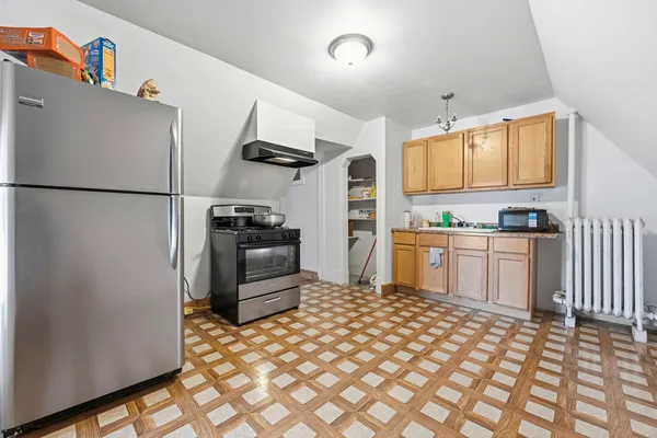 a kitchen with a refrigerator and a sink