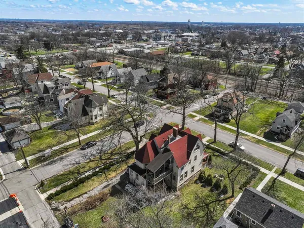 an aerial view of a house with a yard