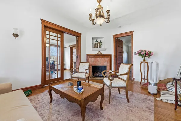 a living room with furniture a fireplace and a table