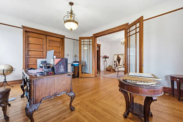a view of a workspace with furniture and a window