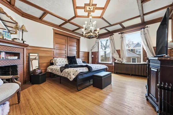 a spacious bedroom with a bed and a large window