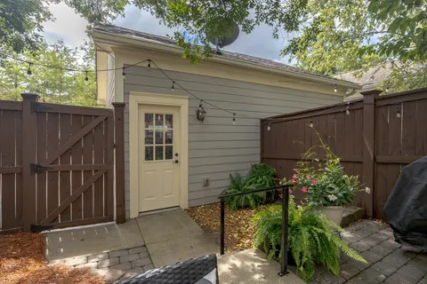 a view of a house with backyard sitting area and garden