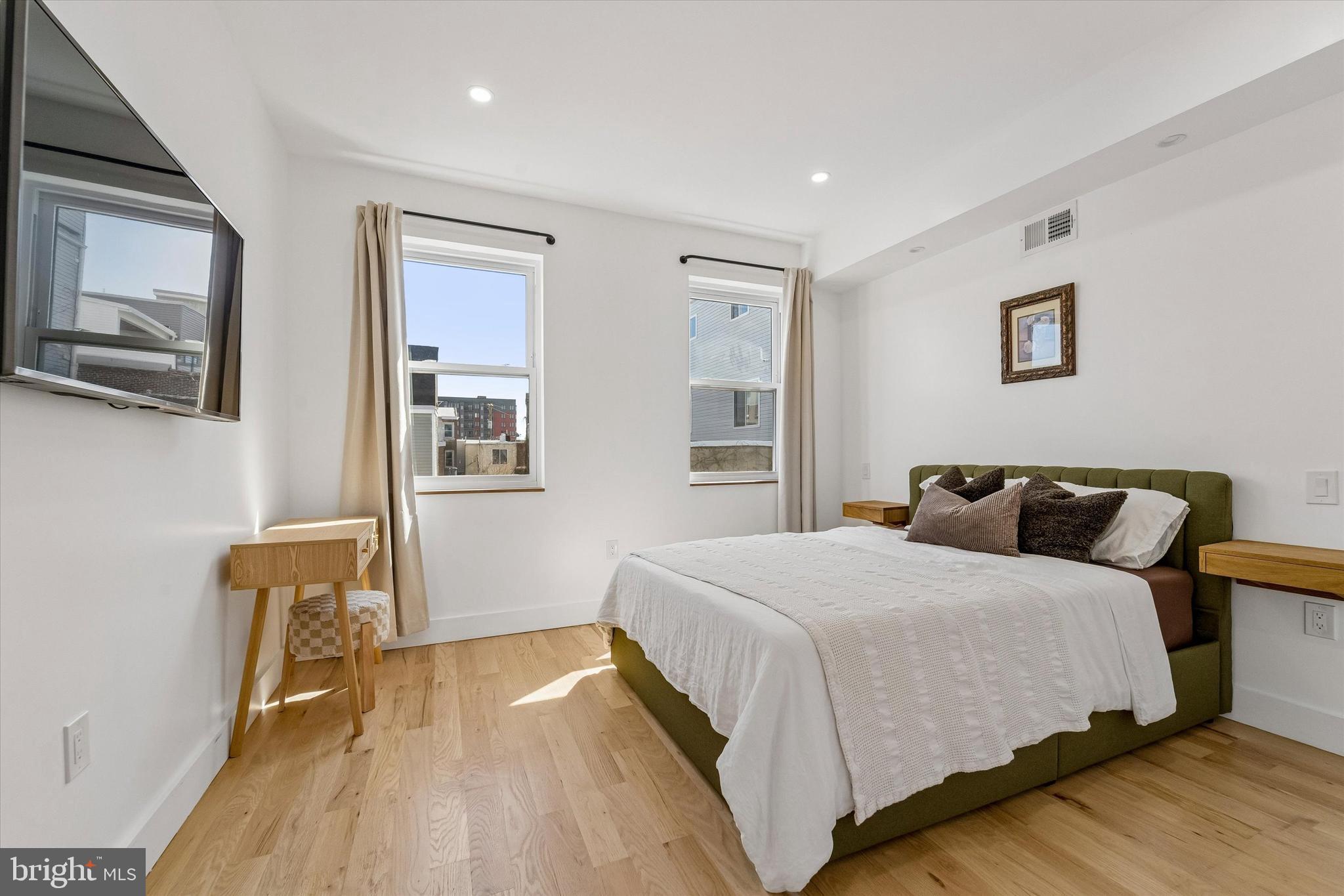 2565 Tulip Street Philadelphia, PA 19125 - Photo 11 of 15 a bedroom with a bed and wooden floor