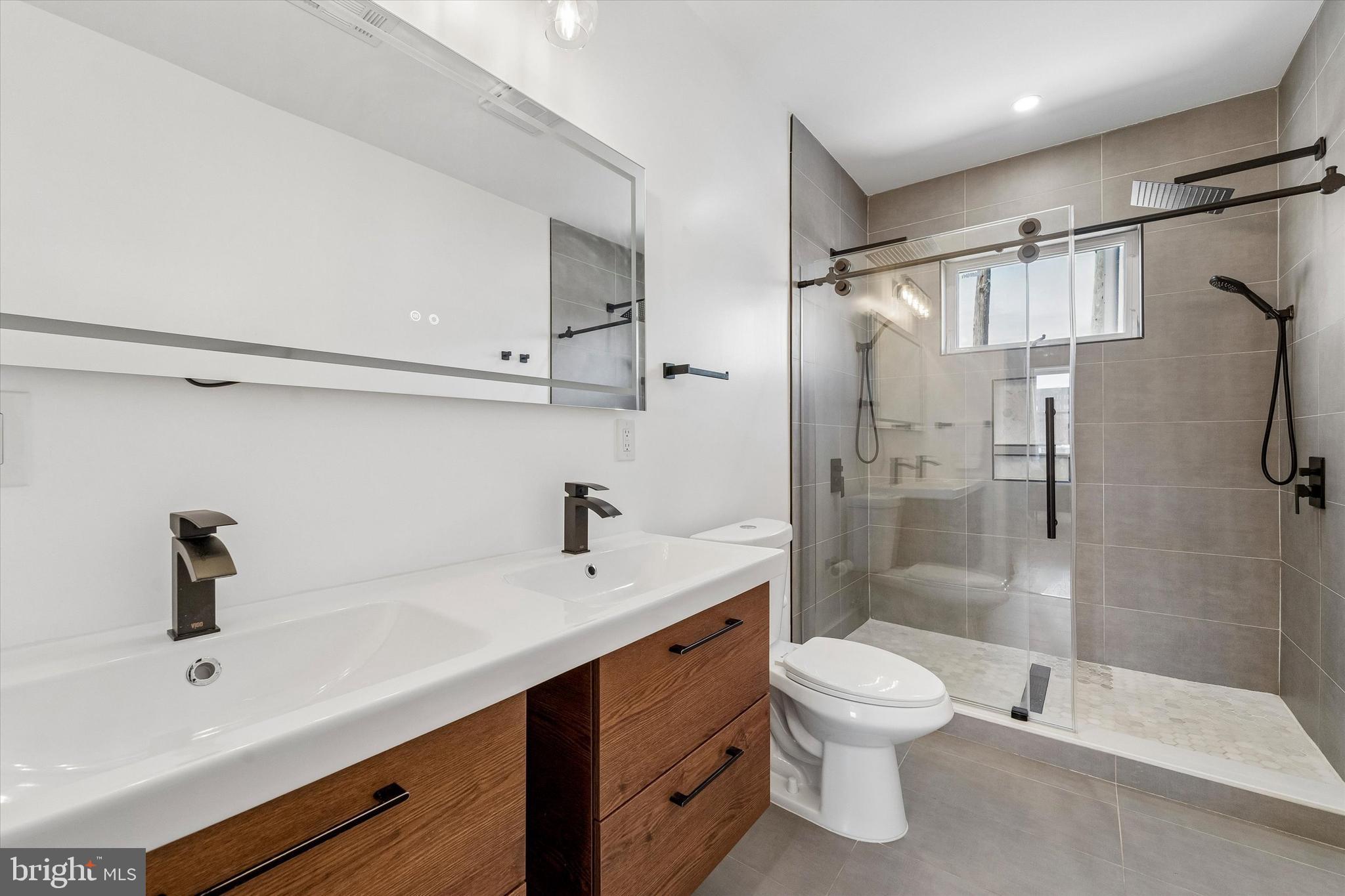 2565 Tulip Street Philadelphia, PA 19125 - Photo 13 of 15 a bathroom with a sink a toilet and shower