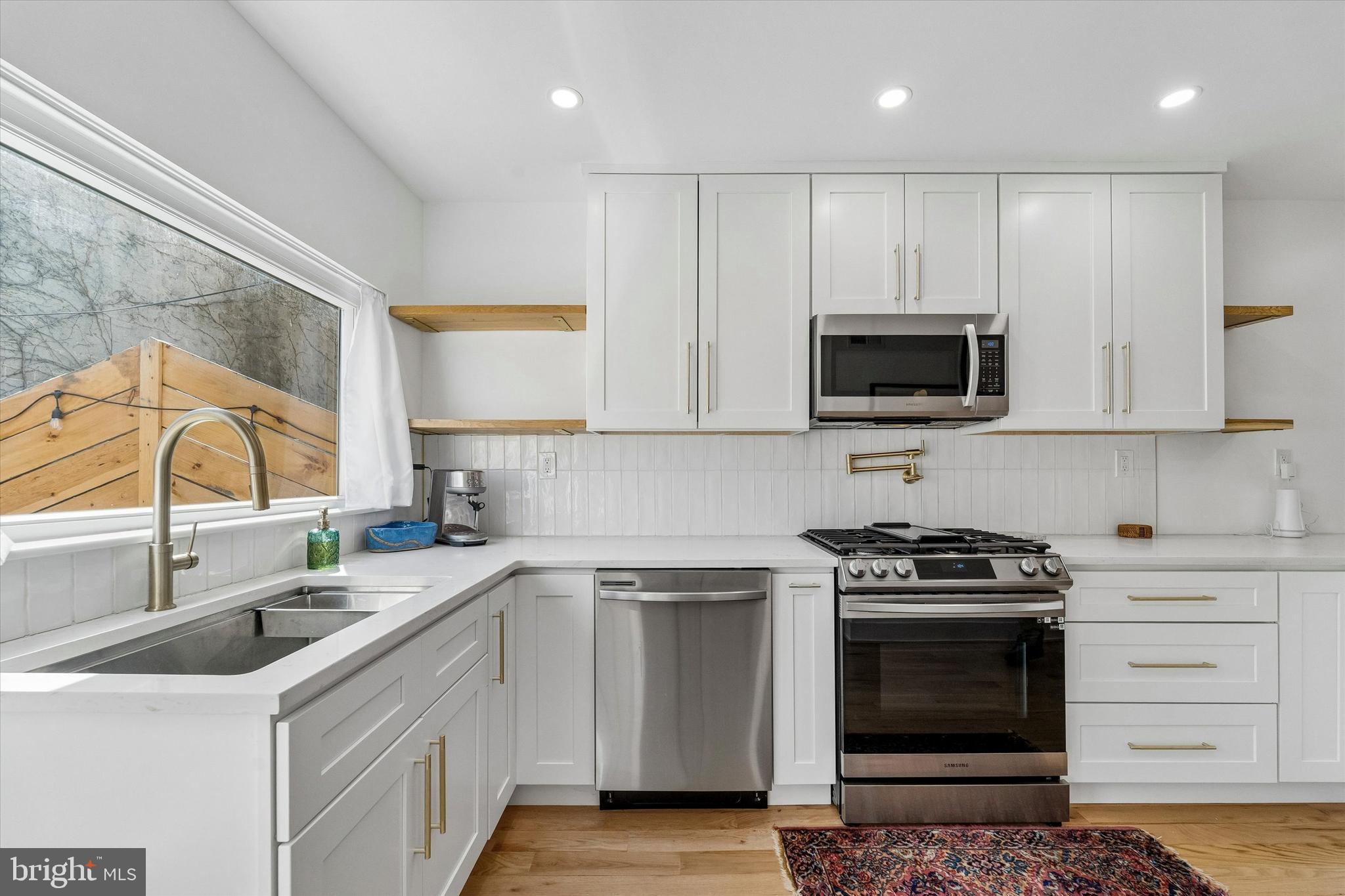2565 Tulip Street Philadelphia, PA 19125 - Photo 6 of 15 a kitchen with stainless steel appliances a stove sink and microwave