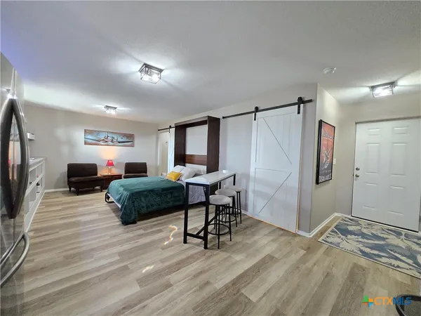 a living room with a bed and a table