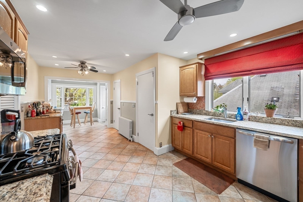39-41 Donnybrook Road Boston, MA 02135 - Photo 22 of 37 a large kitchen with stainless steel appliances granite countertop a stove and cabinets