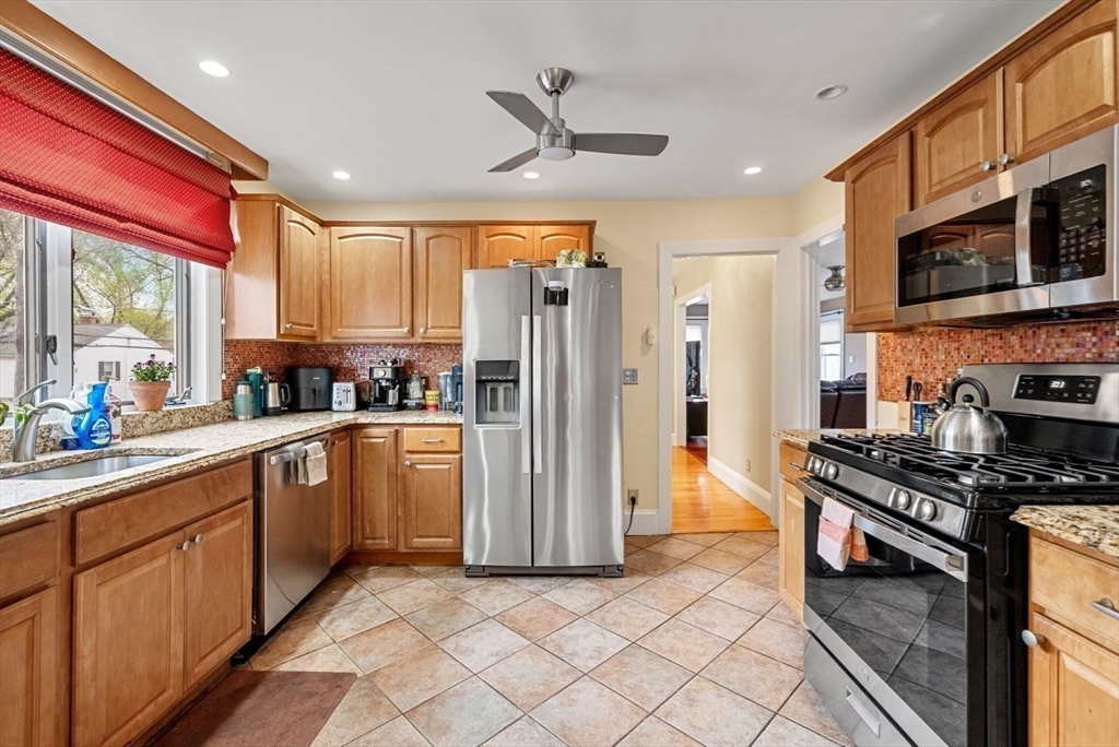 39-41 Donnybrook Road Boston, MA 02135 - Photo 23 of 37 a kitchen with stainless steel appliances granite countertop a refrigerator a sink dishwasher a stove and a oven with wooden floor