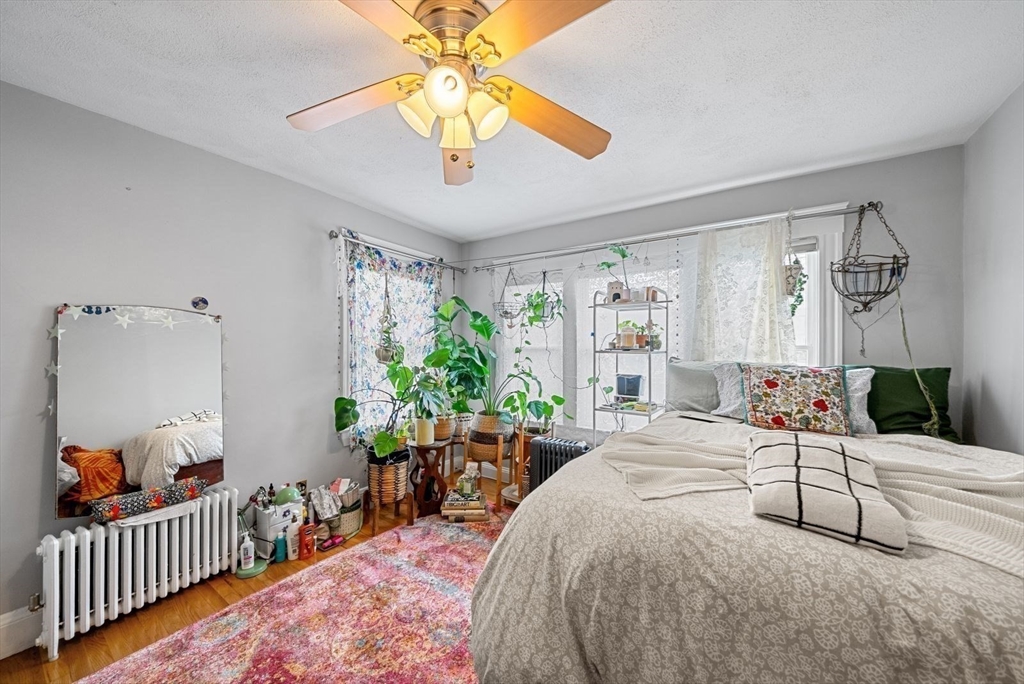39-41 Donnybrook Road Boston, MA 02135 - Photo 26 of 37 a bedroom with a bed and a chandelier