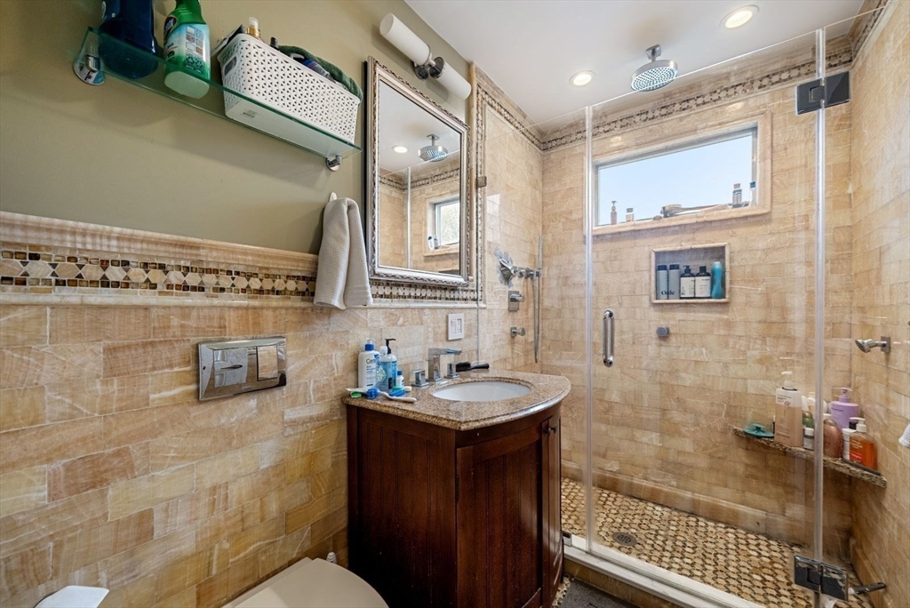 39-41 Donnybrook Road Boston, MA 02135 - Photo 27 of 37 a bathroom with a sink a toilet and shower