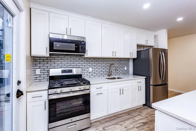 a kitchen with refrigerator cabinets and microwave