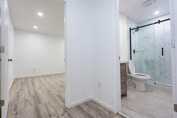 a bathroom with a toilet a sink and shower