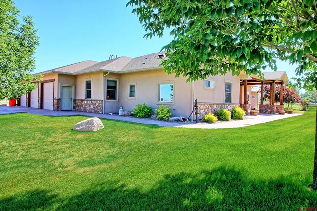 a view of a house with a backyard porch and sitting area