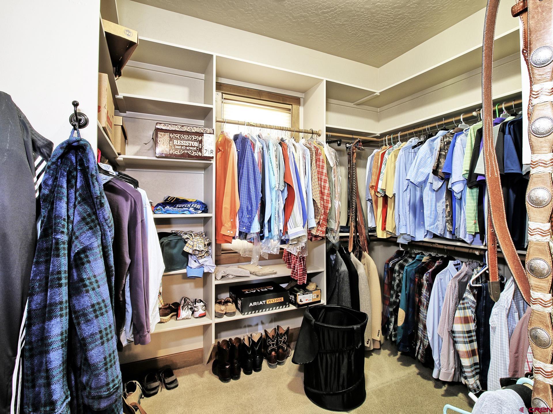 971 24 Road Grand Junction, CO 81505 - Photo 22 of 43 a view of walk in closet with clothes and shoes