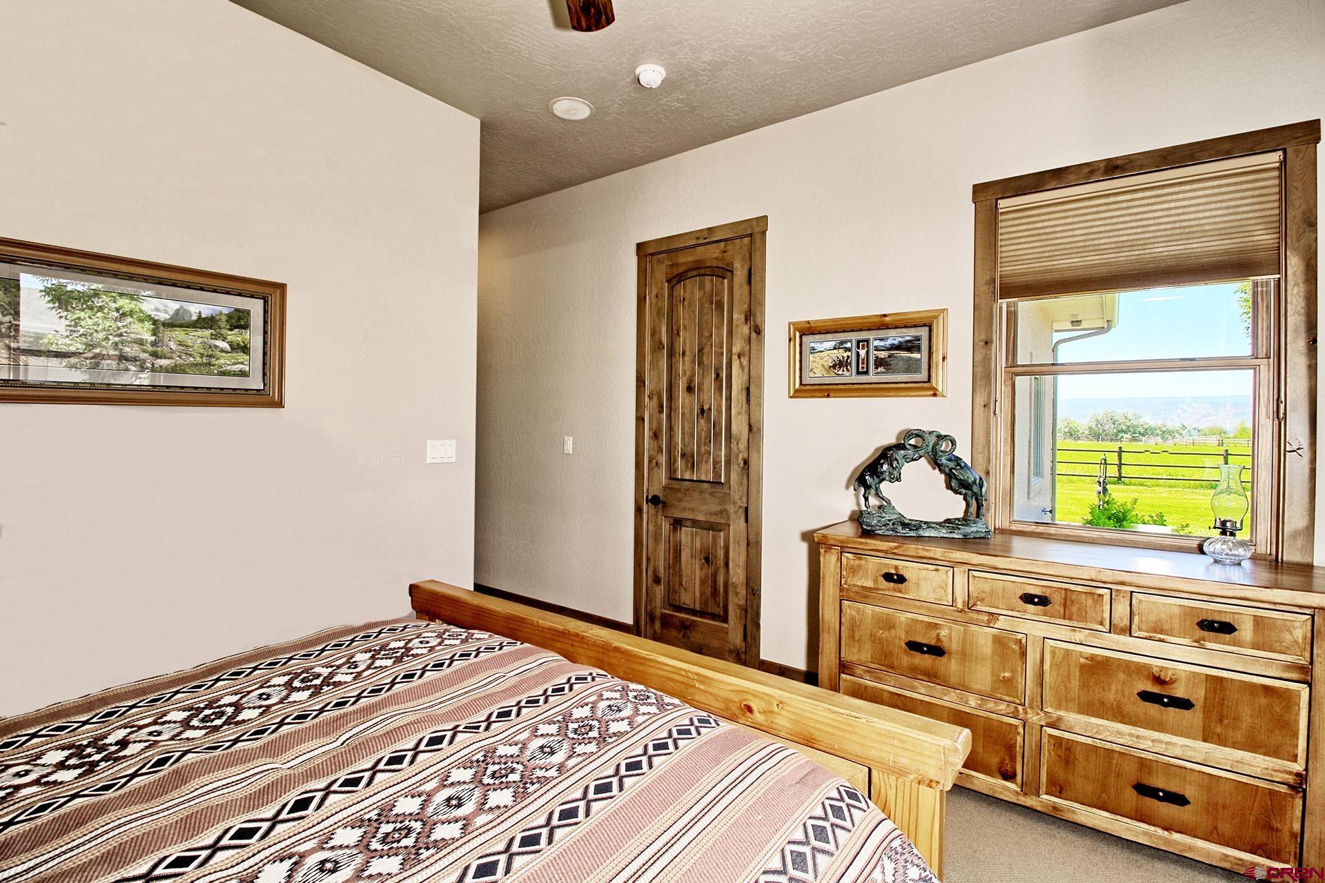 971 24 Road Grand Junction, CO 81505 - Photo 24 of 43 a bedroom with a bed and a dresser