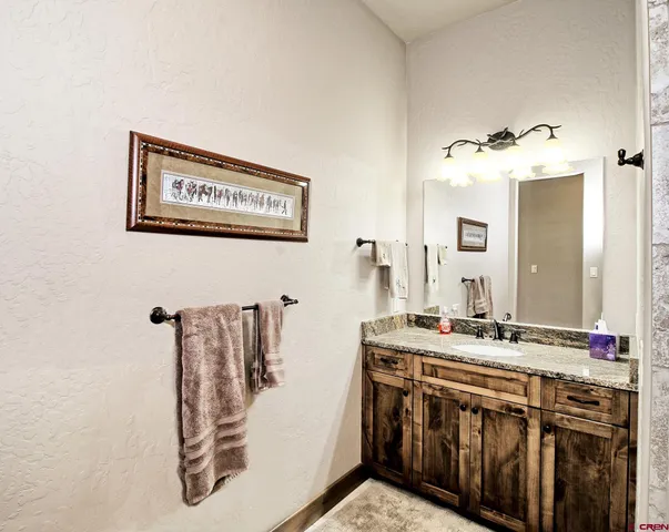 a bathroom with a sink a mirror and shower