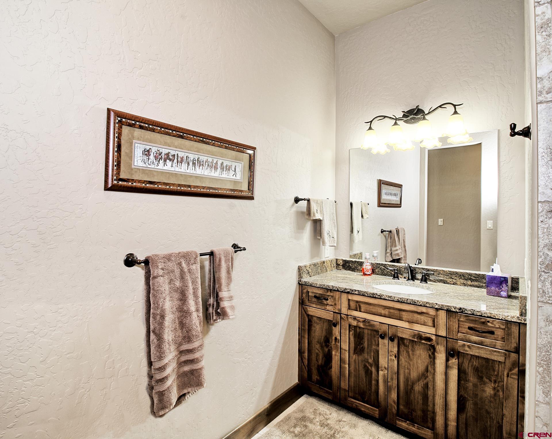 971 24 Road Grand Junction, CO 81505 - Photo 25 of 43 a bathroom with a sink a mirror and shower