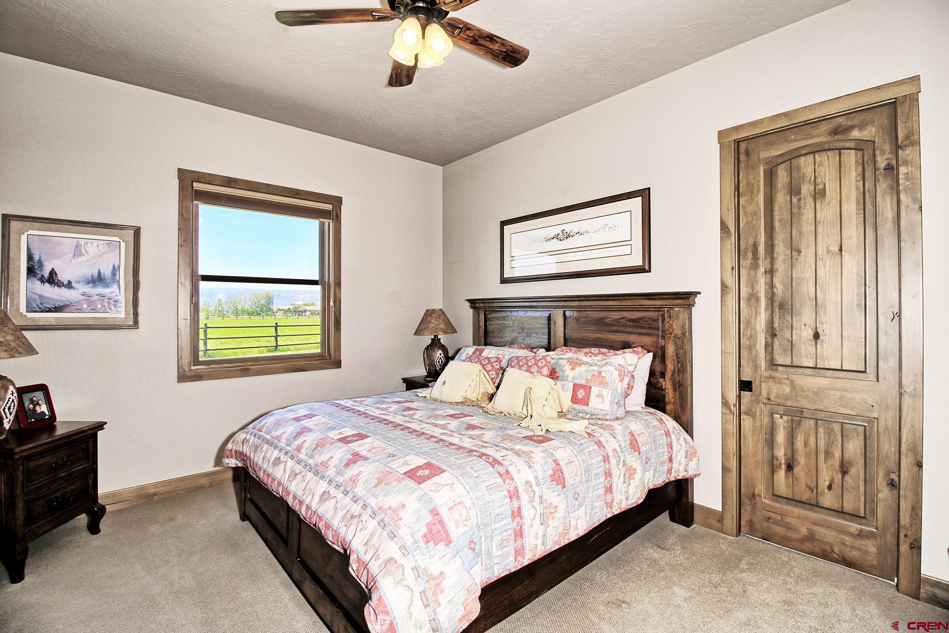 971 24 Road Grand Junction, CO 81505 - Photo 26 of 43 a bedroom with a large bed and a tv