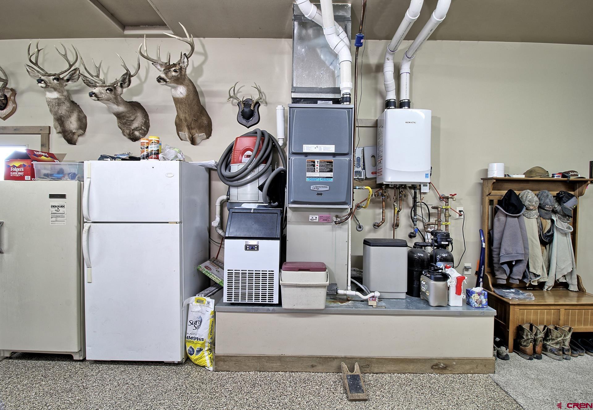 971 24 Road Grand Junction, CO 81505 - Photo 33 of 43 a utility room with lots of clutter and refrigerator