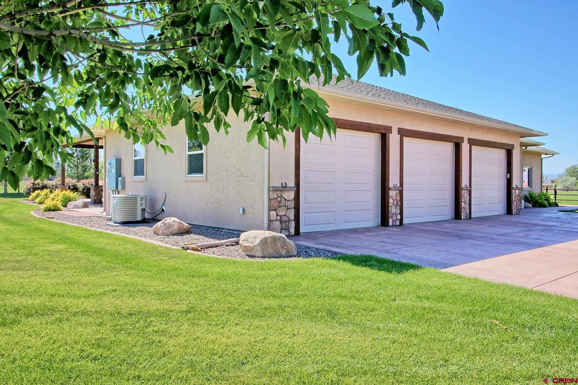 971 24 Road Grand Junction, CO 81505 - Photo 34 of 43 a front view of a house with a garden and yard