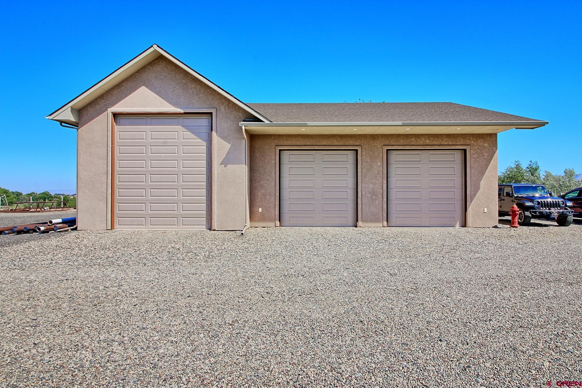 971 24 Road Grand Junction, CO 81505 - Photo 35 of 43 a front view of a house with a yard and garage