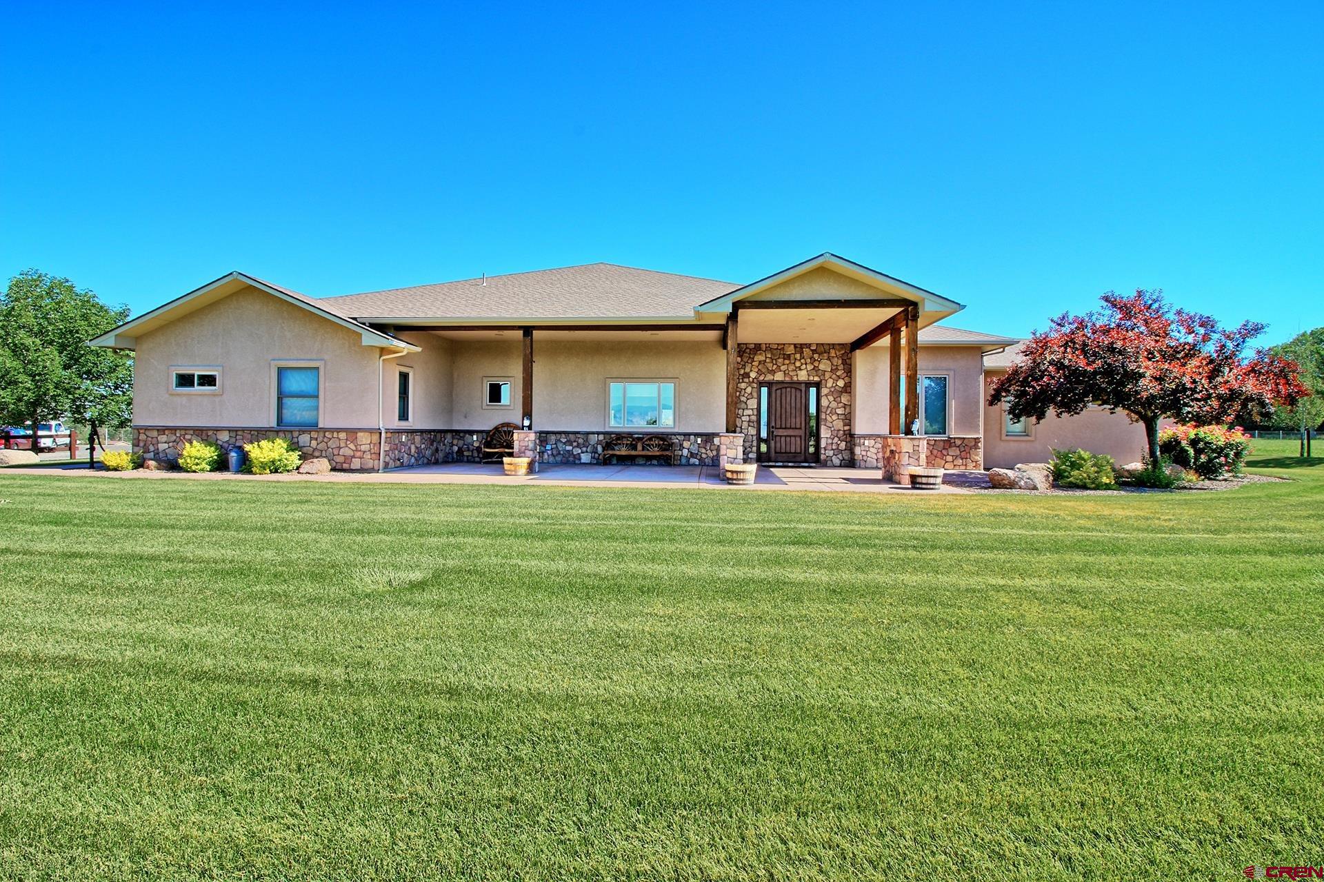 971 24 Road Grand Junction, CO 81505 - Photo 43 of 43 a front view of a house with a yard table and chairs