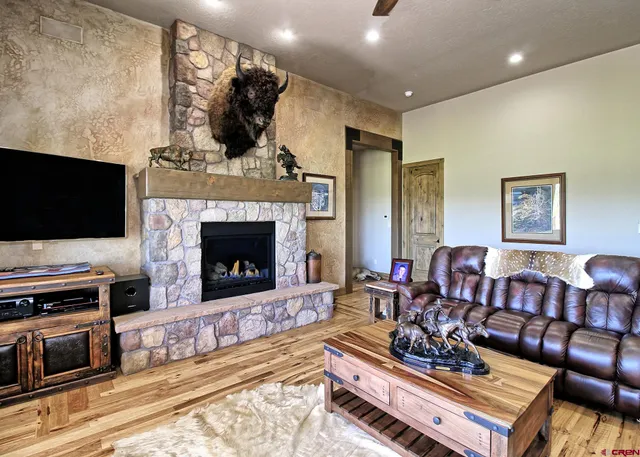 a living room with furniture a flat screen tv and a fireplace