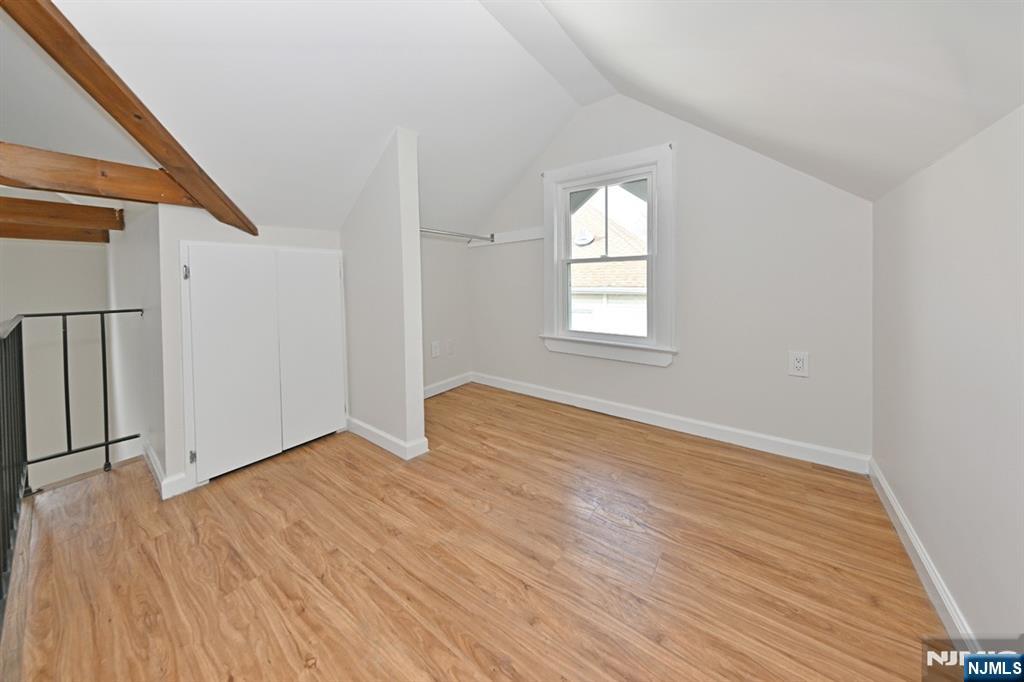 205 Union Street, Unit 2 Ridgewood, NJ 07450 - Photo 11 of 24 an empty room with wooden floor and windows