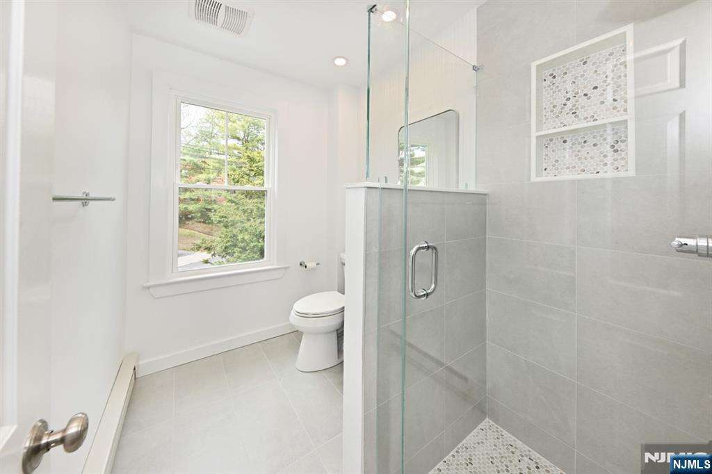 205 Union Street, Unit 2 Ridgewood, NJ 07450 - Photo 21 of 24 a bathroom with a toilet sink and a mirror